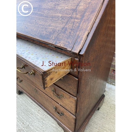 301 - An early Victorian mahogany bureau with a fitted interior