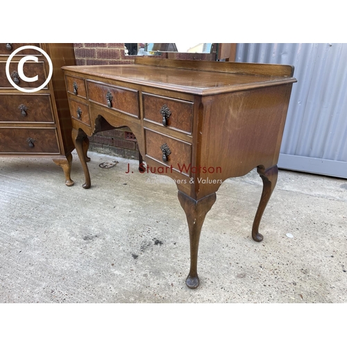 303 - A Queen Anne style walnut bedroom pair consisting of a tallboy chest of five drawers together with a... 