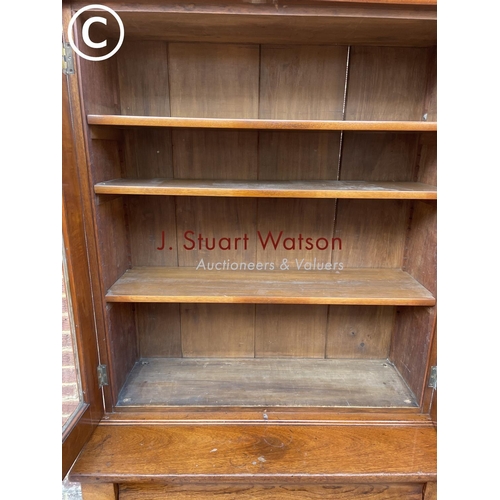 304 - A Victorian Mahogany glazed bookcase cupboard with a single drawer and adjustable shelves