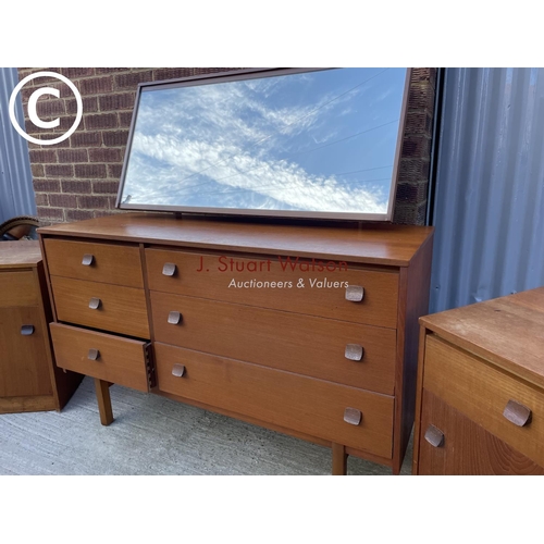 305 - A mid century stag style teak three piece bedroom set consisting of a six drawer dressing chest toge... 