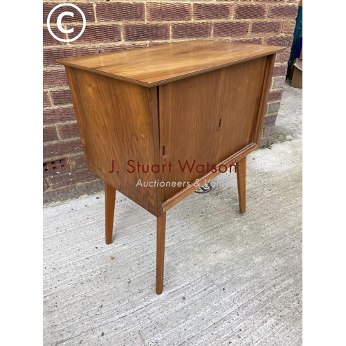 309 - A mid century teak record cupboard