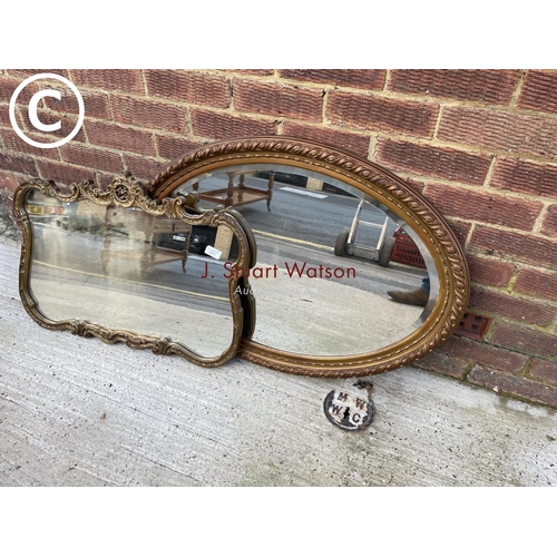 311 - An ornate gold mirror together with an oval mirror