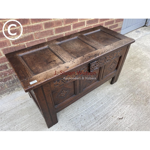 314 - An antique oak carved three panel blanket box coffer