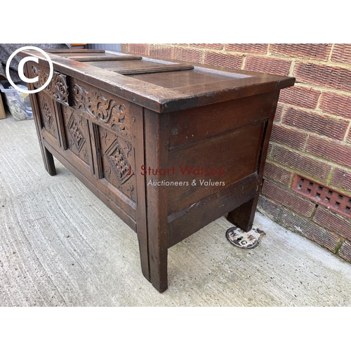 314 - An antique oak carved three panel blanket box coffer