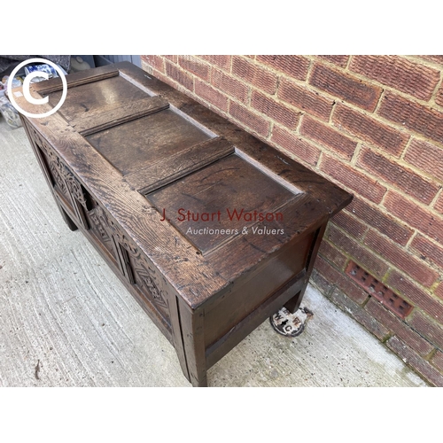 314 - An antique oak carved three panel blanket box coffer