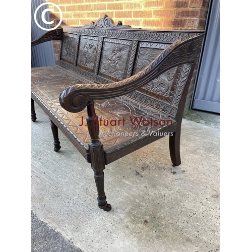 319 - An antique carved oak settle seat