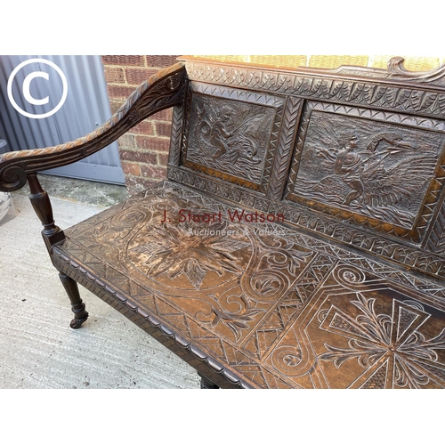 319 - An antique carved oak settle seat