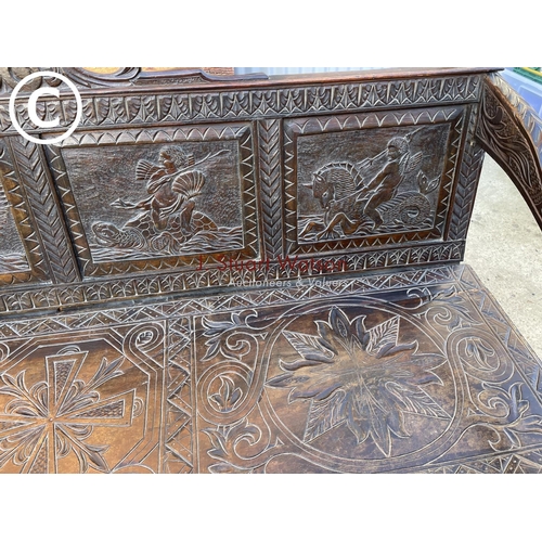 319 - An antique carved oak settle seat