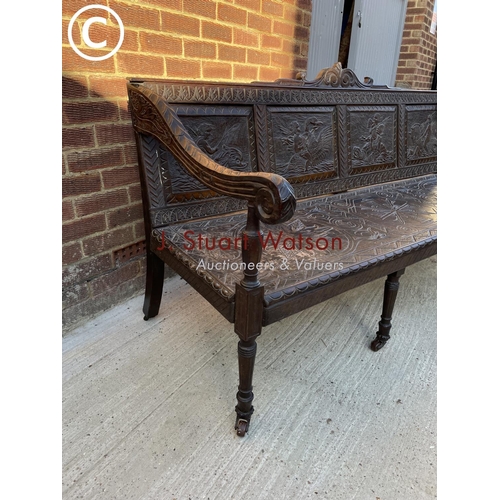 319 - An antique carved oak settle seat