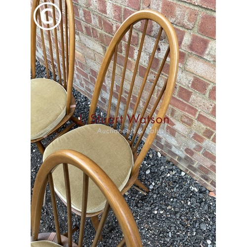 32 - A set of four Ercol golden dawn stick back chairs