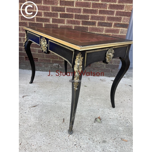 329 - An ebonised Victorian two drawer writing table with red leather top and brass mounts