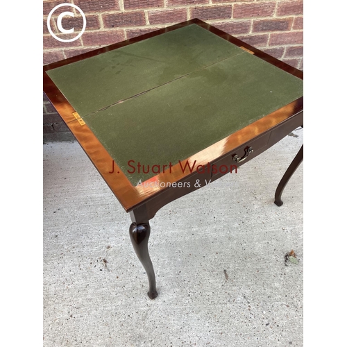 331 - A mahogany fold over card table with a single drawer