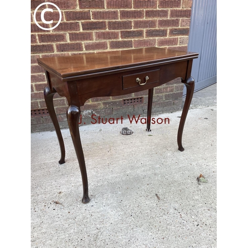 331 - A mahogany fold over card table with a single drawer