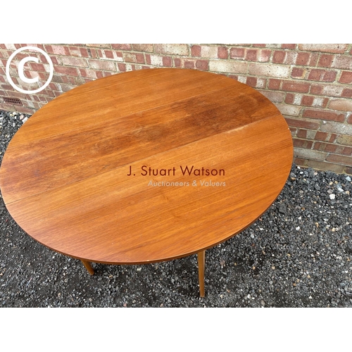 34 - A teak drop leaf dining table