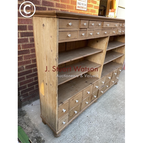 342 - A German pine 36 drawer Apothecary chest with four open pine shelves