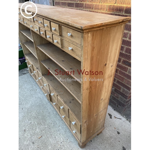 342 - A German pine 36 drawer Apothecary chest with four open pine shelves