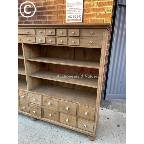 342 - A German pine 36 drawer Apothecary chest with four open pine shelves