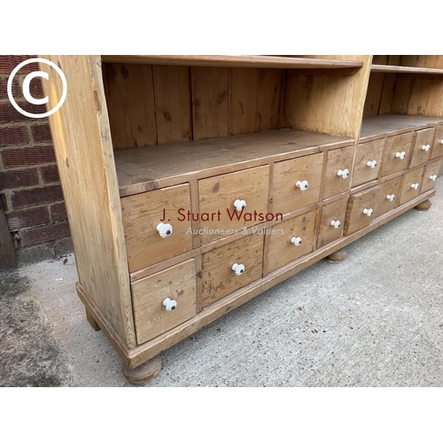 342 - A German pine 36 drawer Apothecary chest with four open pine shelves