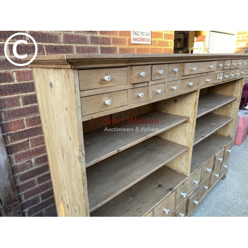 342 - A German pine 36 drawer Apothecary chest with four open pine shelves