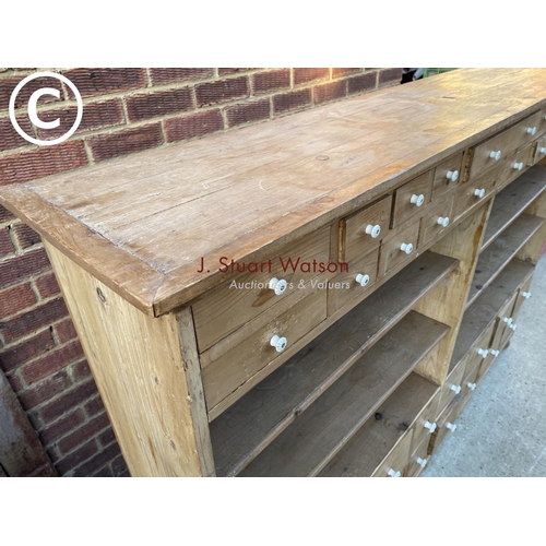 342 - A German pine 36 drawer Apothecary chest with four open pine shelves