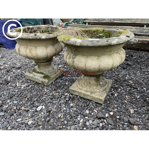 367 - A pair of weathered concrete pedestal urns