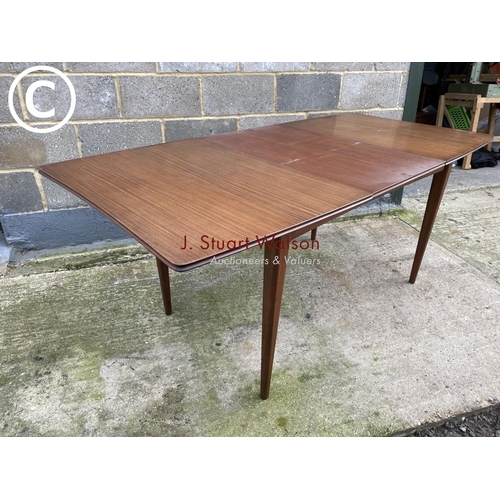 383 - Mcintosh style rectangular teak dining tabke with one extension leaf