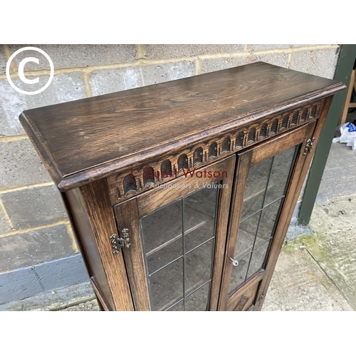 398 - A reproduction glazed oak bookcase