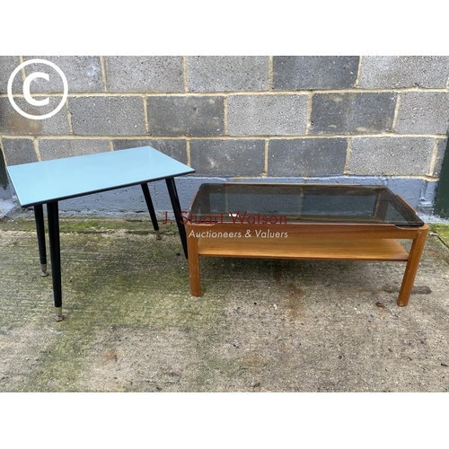 409 - A teak coffee table with a smoked glass,top,together with a retro table