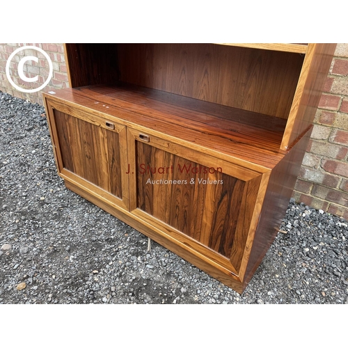 42 - A Danish rosewood bookcase cabinet with a glaze top over shelf and two cupboards