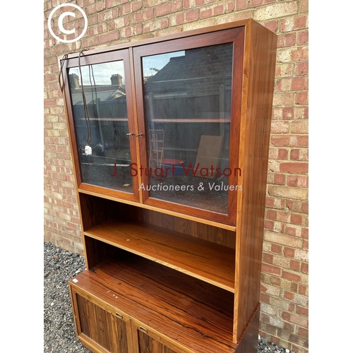 42 - A Danish rosewood bookcase cabinet with a glaze top over shelf and two cupboards