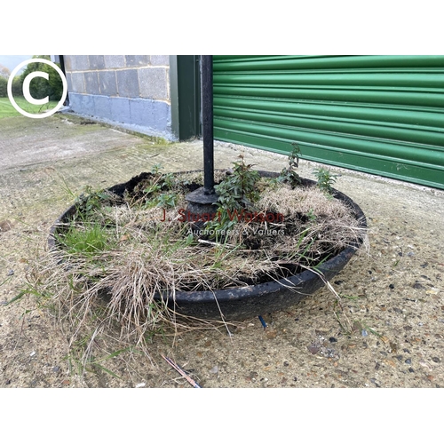 422 - A large cast iron pig trough with later ironwork hook tower formhamgimg baskets