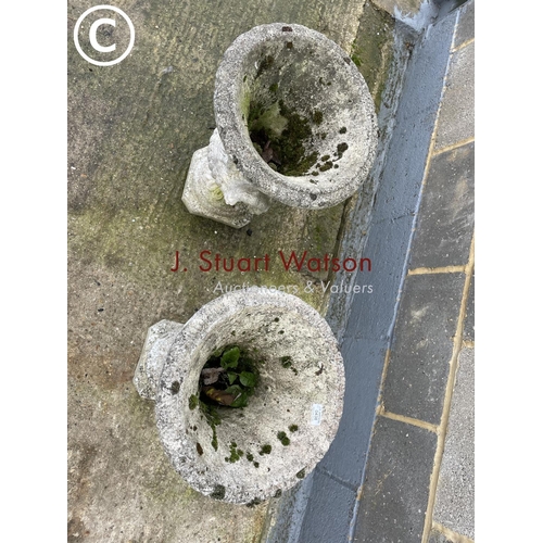 438 - A pair of decorative concrete garden urns 58cm high