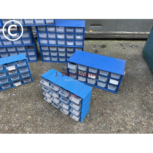 456 - A collection of nine wall mounted blue plastic parts drawers containing fuses