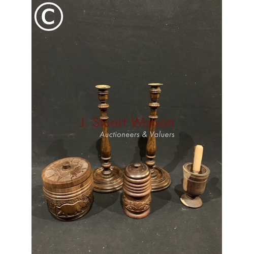 560 - Pair wooden candlesticks, 2 carved wooden pots and wooden grinder