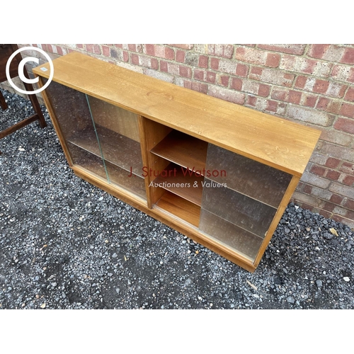 58 - A mid century side by side glazed bookcase