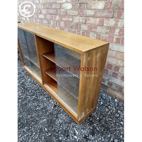 58 - A mid century side by side glazed bookcase