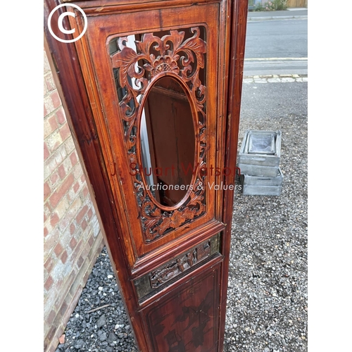 63 - An Oriental four section screen with sliding drop down panels