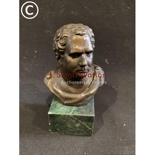 630 - Small bust of a Roman on green base, height 15 cms