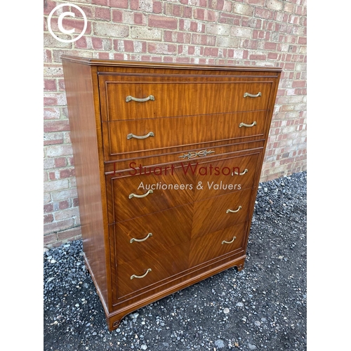 66 - An American mahogany tallboy chest of five drawers with ornate brass handles, labelled to the top dr... 