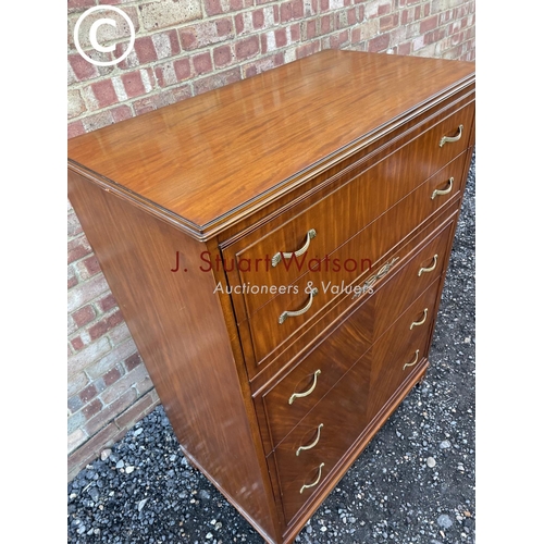 66 - An American mahogany tallboy chest of five drawers with ornate brass handles, labelled to the top dr... 