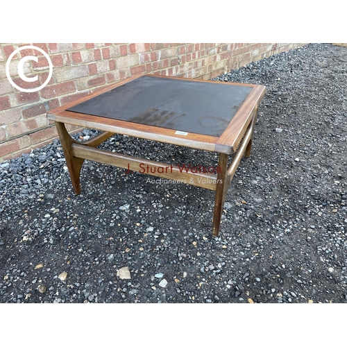 68 - A teak coffee tabke with a drop in glass top by stateroom