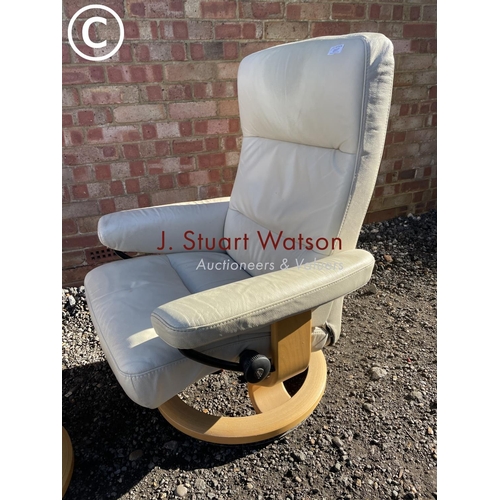 7 - A white leather Stressless reclining chair and stool by ekornes