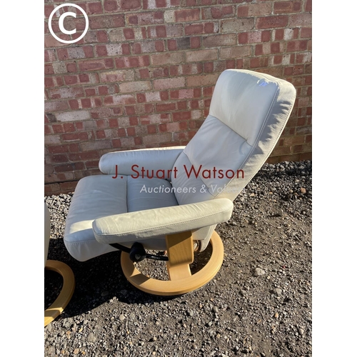 7 - A white leather Stressless reclining chair and stool by ekornes