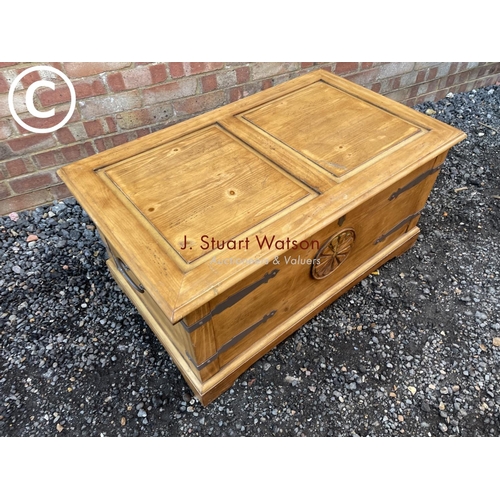 79 - A solid pine blanket box chest with metal bound corners