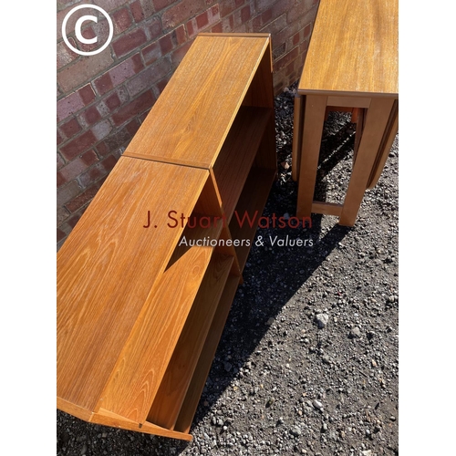 8 - A mid century teak gateleg table together with a teak open fronted bookcase