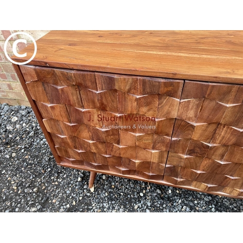 82 - An unusual hardwood sideboard by Swoon with three drawers and two doors