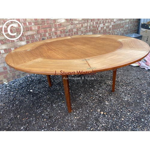 83 - A mid century teak extending  'Flip Flap' table by dyrlund with drawer leaf fold over extensions