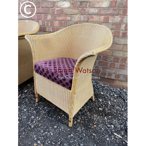 87 - A set of three modern LLoyd loom chairs manufactured in Spalding UK with purple seat cushions