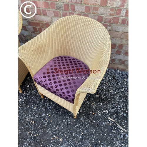 87 - A set of three modern LLoyd loom chairs manufactured in Spalding UK with purple seat cushions