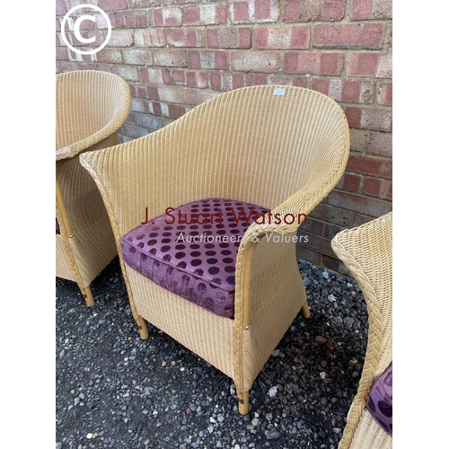 87 - A set of three modern LLoyd loom chairs manufactured in Spalding UK with purple seat cushions